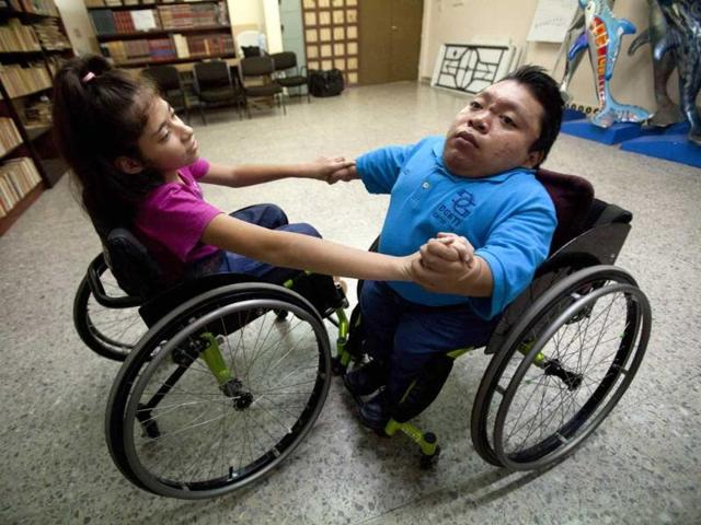 Lucia Tejero and Juan Poot train in a library before the First Regional Dance Competition on Wheelchair Sports in Cancun. Reuters/Victor Ruiz Garcia 
