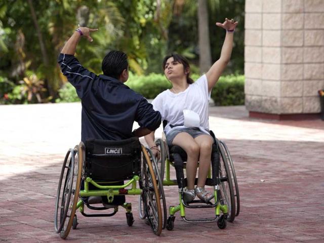 Jazmin Lopez and Miguel Osorio train outside a basketball court before the First Regional Dance Competition on Wheelchair Sports in Cancun. Reuters/Victor Ruiz Garcia 
