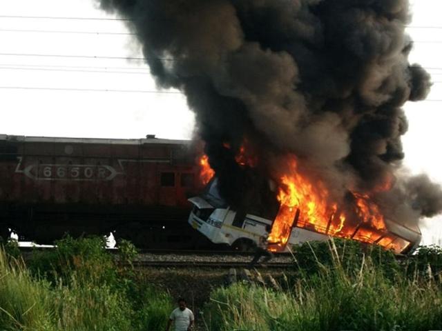 A-college-bus-is-seen-on-fire-after-a-train-rammed-into-it-killing-at-least-seven-people-in-Bihar-s-Siwan-district-HT A-college-bus-is-seen-on-fire-after-a-train-rammed-into-it-killing-at-least-seven-people-in-Bihar-s-Siwan-district-HT