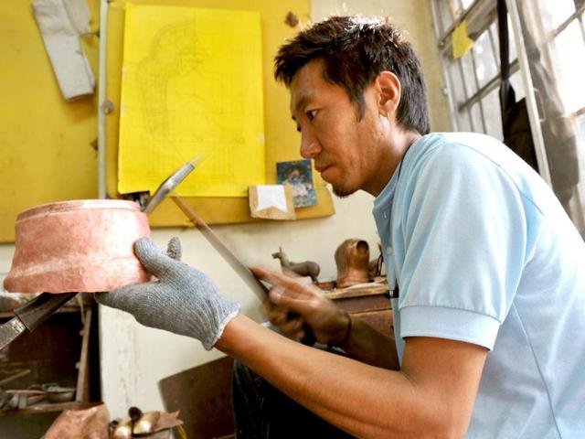 A traditional Tibetan craftsman hand sculpts a metal figurine of the Buddha at the Norbulingka Institute near Dharamshala. The Norbulingka Institute is a centre for arts dedicated to the preservation of Tibetan art and culture. (AFP Photo)