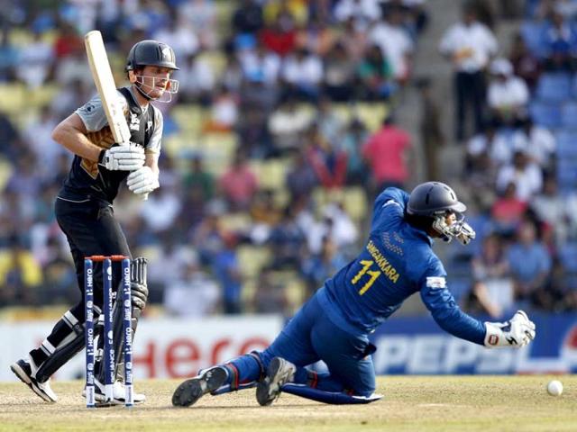 New Zealand's batsman Rob Nicol, left, watches Sri Lanka's wicketkeeper Kumar Sangakkara, right, fails to stop his shot during the ICC Twenty20 Cricket World Cup Super Eight match in Pallekele. (AP Photo/Aijaz Rahi)
