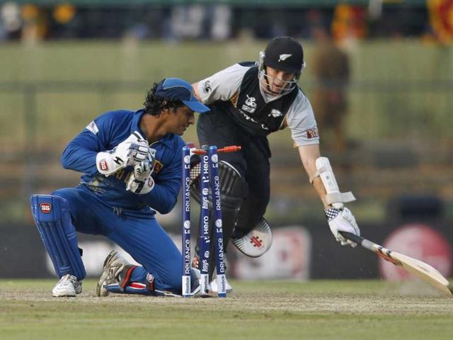 Sri Lanka's wicketkeeper Kumar Sangakkara runs out New Zealand's Kane Williamson (R) during their Twenty20 World Cup cricket match in Pallekele. (Reuters/Dinuka Liyanawatte)