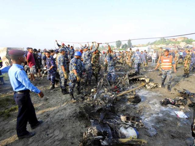 Rescuers are seen near the wreckage of an Sita Air Dornier plane crash site in Manohara, on the outskirts of Kathmandu. AFP/Prakash Mathema