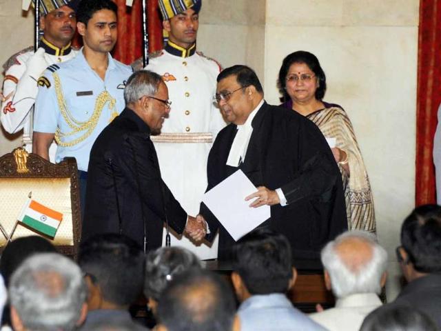 Chief Justice of India Altamas Kabir shakes hands with President Pranab Mukherjee after swearing in as the new Chief Justice of India at Rashtrapati Bhavan in New Delhi. UNI