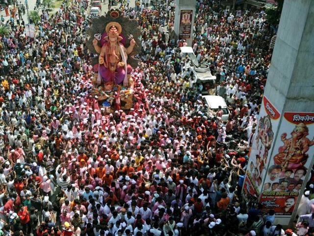 Devotees gather around a huge idol of Lord Ganesha during the procession for immersion into the Arabian Sea, on the streets of Mumbai. AFP photo