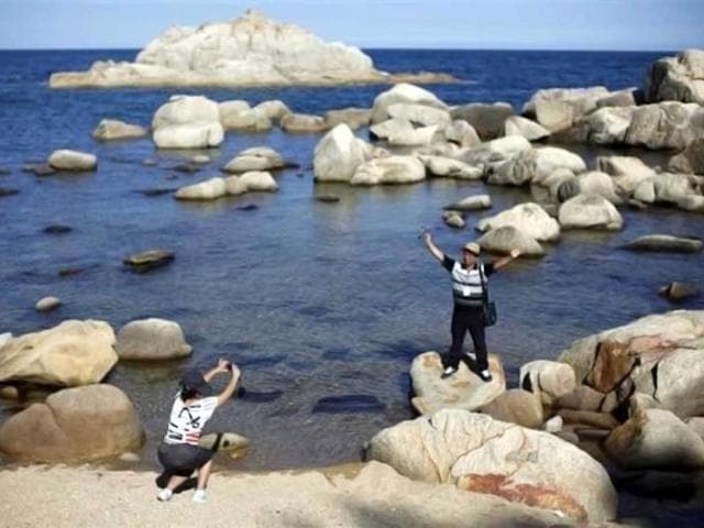 A-member-of-a-Chinese-delegation-takes-pictures-at-the-costal-area-of-the-Mount-Kumgang-resort-in-Kumgang-North-Korea-Reuters-Carlos-Barria A-member-of-a-Chinese-delegation-takes-pictures-at-the-costal-area-of-the-Mount-Kumgang-resort-in-Kumgang-North-Korea-Reuters-Carlos-Barria