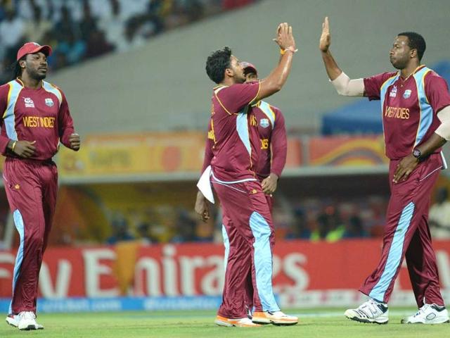 West Indies bowler Ravi Rampaul (C) celebrates after taking the wicket of unseen Sri Lankan batsman Tillakaratne Dilshan with teammates Chris Gayle (L) and Kieron Pollard (R) during the ICC Twenty20 Cricket World Cup's Super Eight match between Sri Lanka and West Indies in Pallekele. AFP Photo/Prakash Singh