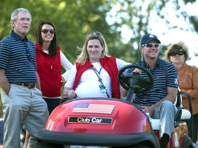 Former US president George W Bush (L) watches golf during the afternoon Four Ball Match on the second day of the 39th Ryder Cup at the Medinah Country Club in Medinah, Illinois. AFP Photo