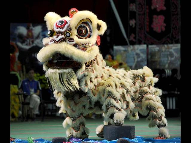 Italian team members perform a lion dance during the world championships in Hong Kong. A total of eight teams take part in the lion dance which is a form of traditional dance in Chinese culture, in which performers mimic a lion's movements in a lion costume. (AFP photo/Laurent Fievet)