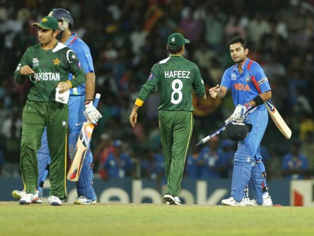 Virat Kohli, right, shakes hands with Mohammad Hafeez after beating them by 8 wickets in the ICC Twenty20 Cricket World Cup Super Eight match between India and Pakistan in Colombo. (AP Photo/Eranga Jayawardena)