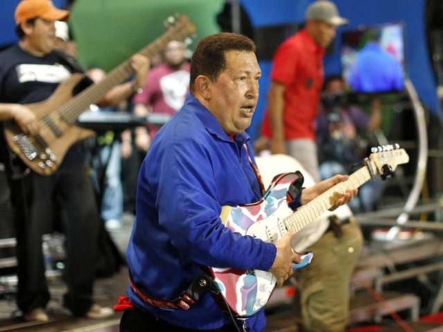 Venezuela's President Hugo Chavez plays a guitar during a campaign rally in Cabimas in the state of Zulia. Reuters Photo