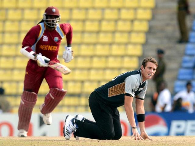 New Zealand cricketer Tim Southee (R) makes an unsuccessful attempt to field the ball as West Indies cricketer Chris Gayle takes a run during the ICC Twenty20 Cricket World Cup's Super Eight match between New Zealand and West Indies at the Pallekele International Cricket Stadium in Pallekele . AFP Photo/Prakash Singh