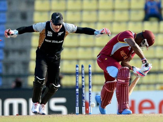 New Zealand cricketer Brendon McCullum (L) celebrates the clean bowl of West Indies cricketer Darren Bravo (R) by Nathan McCullum during the ICC Twenty20 Cricket World Cup's Super Eight match between New Zealand and West Indies at the Pallekele International Cricket Stadium in Pallekele. AFP Photo/Prakash Singh