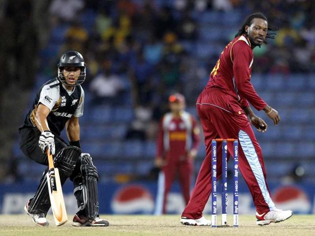 West Indies' bowler Chris Gayle, right, watches the ball as New Zealand's captain Ross Taylor runs to make it to the crease during their ICC Twenty20 Cricket World Cup Super Eight match in Pallekele, Sri Lanka. (AP Photo/Aijaz Rahi)