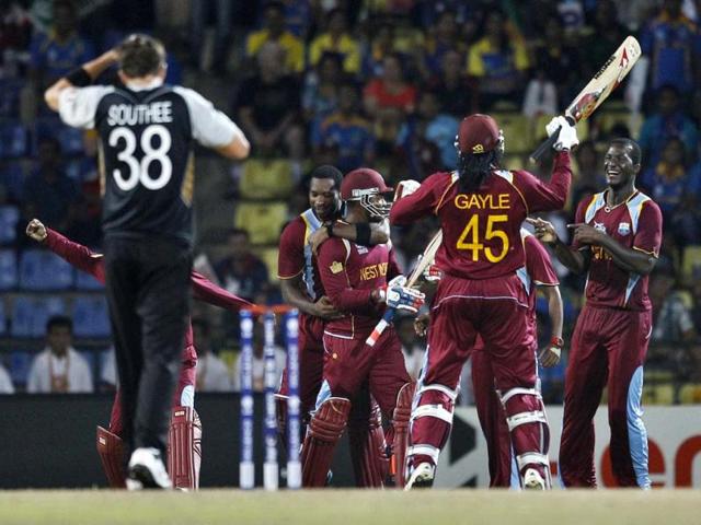 West Indies' captain Darren Sammy, right, celebrates with teammates their Super Over win over New Zealand in their ICC Twenty20 Cricket World Cup Super Eight match in Pallekele. (AP Photo/Aijaz Rahi)