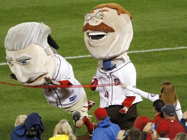 The George Washington mascot dives across the line to edge out Teddy Roosevelt (R) to win the nightly Presidents Race during the fourth inning of the MLB National League baseball game between the Philadelphia Phillies and Washington Nationals in Washington. Reuters Photo