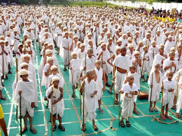 School students, dressed up as Mahatma Gandhi, take part in an event to mark 143rd birth anniversary of the father of the nation in Ahmedabad. PTI