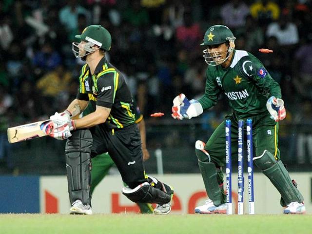 Australian cricketer Matthew Wade is bowled out by Pakistan cricketer Saeed Ajmal as Pakistan wicket keeper Kamran Akmal (R) looks on during the ICC Twenty20 Cricket World Cup's Super Eight match between Australia and Pakistan at the R Premadasa International Cricket Stadium in Colombo. AFP Photo/ Ishara S.Kodikara