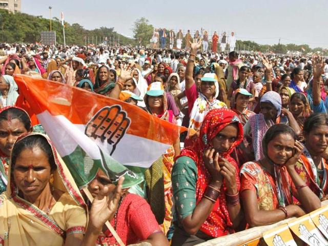 Congress supporters listen to the speech by party president Sonia Gandhi during an election campaign rally ahead of state assembly elections at Rajkot. Reuters photo