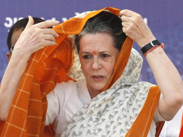 Congress president Sonia Gandhi adjusts her saree during an election campaign rally ahead of state assembly elections at Rajkot. Reuters photo