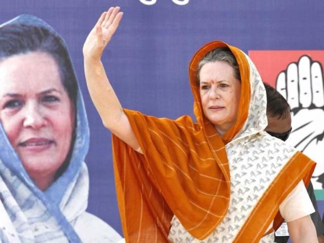 Congress president Sonia Gandhi waves to her supporters during an election campaign rally ahead of state assembly elections at Rajkot. Reuters photo