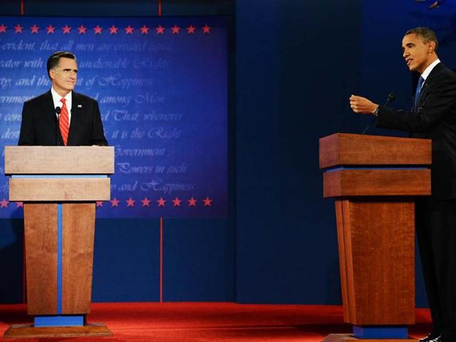 Former Massachusetts governor Mitt Romney listens as President Barack Obama speaks during their first presidential debate at the University of Denver. AP/The Denver Post, John Leyba