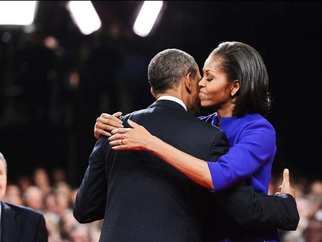 US President Barack Obama is embraced by US First Lady Michelle Obama following Mr. Obama's debate with Republican presidential candidate Mitt Romney at the University of Denver in Denver, Colorado. (AFP Photo)