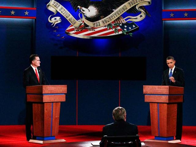 US President Barack Obama answers a question as Republican presidential nominee Mitt Romney listens during the first presidential debate in Denver. (Reuters)