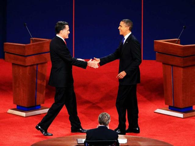 Democratic presidential candidate, US President Barack Obamashakes hands with Republican presidential candidate, former Massachusetts Gov. Mitt Romney during the Presidential Debate at the University of Denver in Denver, Colorado. (AFP Photo)