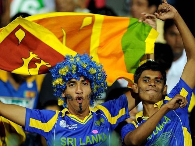 Sri Lanka cricket team fans cheer during the ICC Twenty20 Cricket World Cup semi-final match between Sri Lanka and Pakistan at the R Premadasa International Cricket Stadium in Colombo. AFP Photo/Ishara S Kodikara