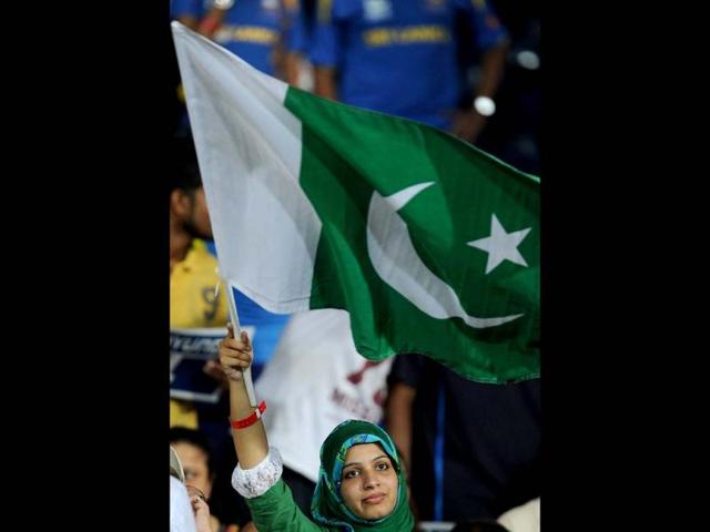 A Pakistan fan waves a national flag during the ICC Twenty20 Cricket World Cup's semi-final match between Sri Lanka and Pakistan at the R Premadasa International Cricket Stadium in Colombo. AFP Photo/ Lakruwan Wanniarachchi