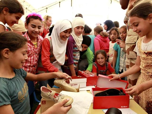 Syrian child refugees look at gifts from Corinne Breuze, French ambassador to Jordan, and Dominique Hyde, director of UNICEF in Jordan, during the official opening of the first school at Al Zaatri refugee camp, in the Jordanian city of Mafraq, near the border with Syria. Reuters/Muhammad Hamed