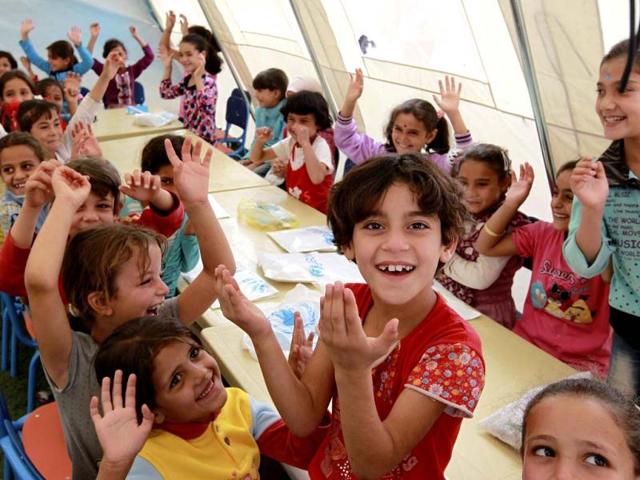 Syrian child refugees pose during their fourth day of school at Al Zaatri refugee camp, in the Jordanian city of Mafraq, near the border with Syria. Reuters/Muhammad Hamed