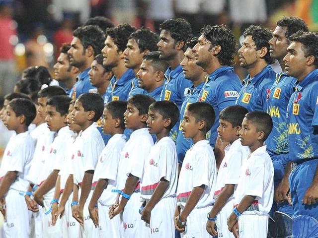 Sri Lankan cricketers observe their national anthem before the start during the ICC Twenty20 Cricket World Cup semi-final match between Sri Lanka and Pakistan at the R Premadasa International Cricket Stadium in Colombo. AFP Photo/Lakruwan Wanniarachchi