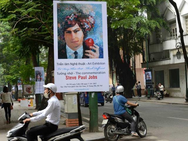 Posters featuring an art exhibition for the commemoration of the late Apple's co-founder Steve Jobs on the occasion of his first death anniversary are seen hung along a street in Hanoi. AFP Photo/Hoang Dinh Nam