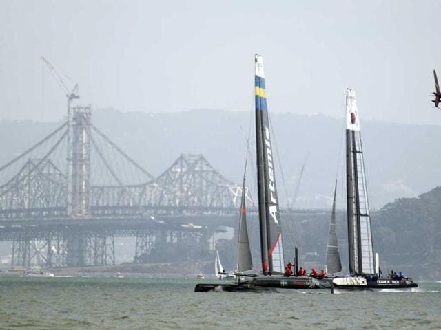 Artemis Team White of Sweden races against Team Korea with the San Francisco-Oakland Bay Bridge in the background during their quarterfinal match race of the America's Cup World Series sailing event in San Francisco. Artemis Team White won their race. AP/Eric Risberg
