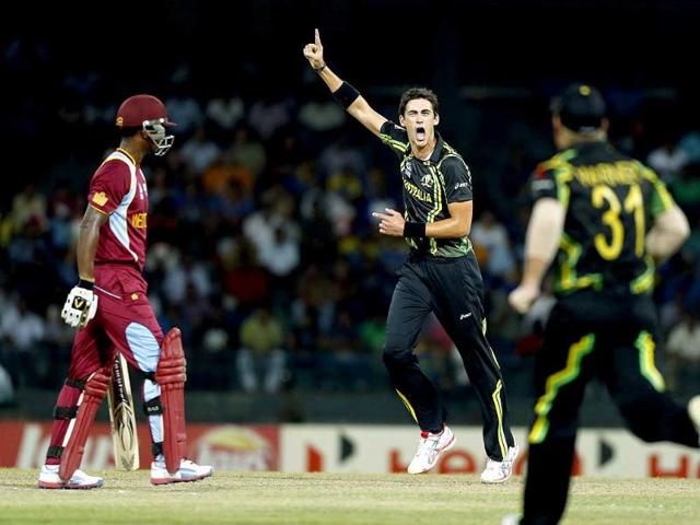 Australia bowler Mitchell Starc (2R) celebrates after taking the wicket of West Indies batsman Johnson Charles, left, during the ICC Twenty20 Cricket World Cup semi final match in Colombo. AP Photo/Eranga Jayawardena