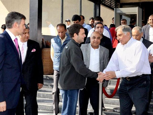 Jammu and Kashmir chief minister Omar Abdullah looks on as Congress leader Rahul Gandhi and industrialist Ratan Tata shake hands at a business luncheon meeting in Srinagar. PTI Photo