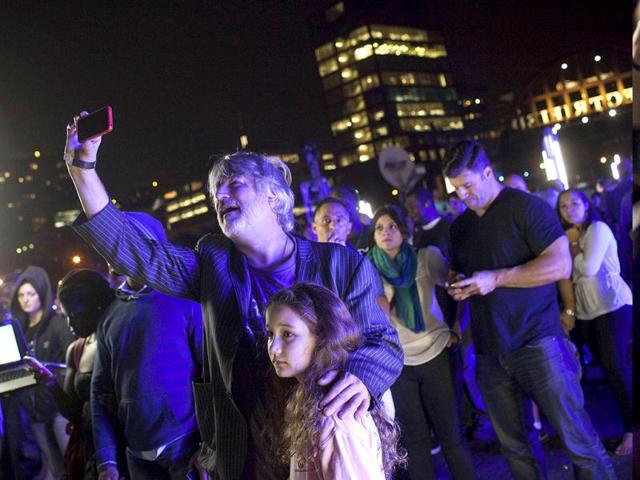 People watch as magician David Blaine channels bolts of electricity from various tesla coils charged with one million volts of electricity during a stunt on Pier 54 in New York. Reuters/Andrew Burton