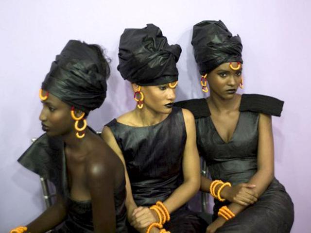 Models, wearing Adama Paris creation, wait in the backstage before the Black Fashion Week show in Paris. AFP photo
