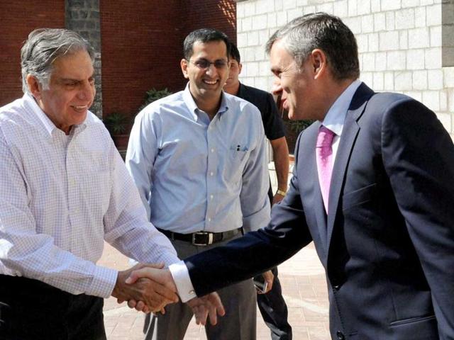 Jammu and Kashmir chief minister Omar Abdullah and Tata Group chairman Ratan Tata shake hands before a breakfast meeting in Srinagar. PTI Photo