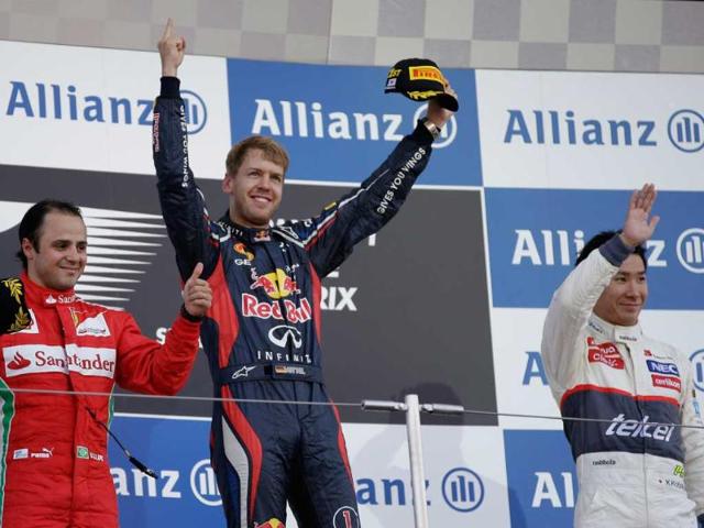 Red Bull driver Sebastian Vettel of Germany celebrates on the podium after winning the Japanese Formula One Grand Prix at the Suzuka Circuit in Suzuka, Japan. (AP Photo/Mark Baker) 