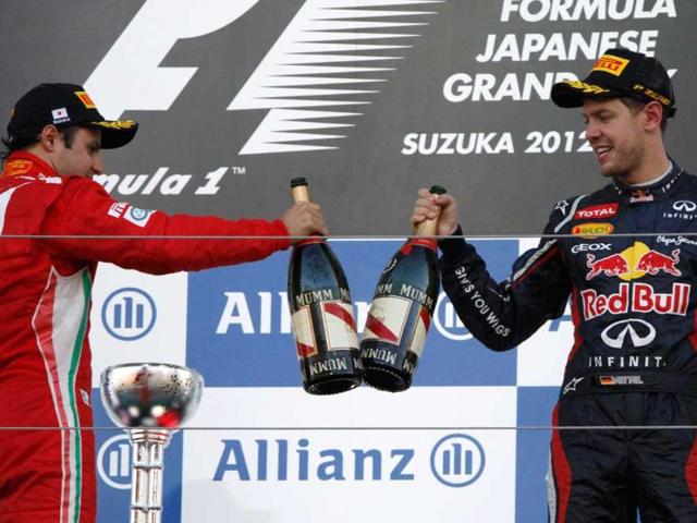Second placed Ferrari Formula One driver Felipe Massa (L) of Brazil celebrates with winner Red Bull Formula One driver Sebastian Vettel of Germany during the podium ceremony following the Japanese F1 Grand Prix at the Suzuka circuit. (Reuters/Issei Kato) 