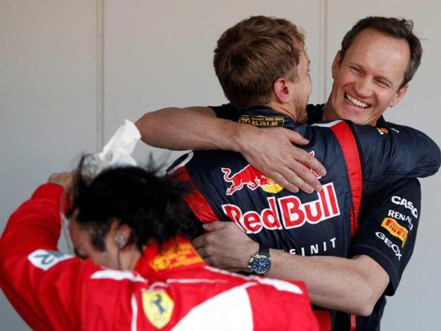 Red Bull Formula One driver Sebastian Vettel (C) of Germany hugs his race engineer Paul Monaghan after winning the Japanese F1 Grand Prix at the Suzuka circuit. (Reuters/Issei Kato) 
