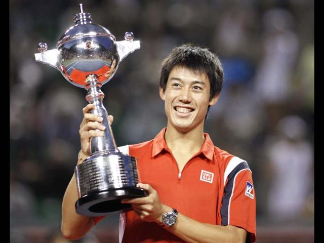 Kei Nishikori of Japan celebrates with his trophy after his victory against Milos Raonic of Canada in the men's singles finals match at the Japan Open tennis championships in Tokyo. Reuters/Yuriko Nakao