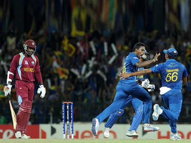 Sri Lankan cricketer Ajantha Mendis (C) celebrates the dismissal of West Indies batsman Chris Gayle (L) during the ICC Twenty20 Cricket World Cup final match between Sri Lanka and West Indies at the R Premadasa International Cricket Stadium in Colombo. AFP Photo/Ishara S. Kodikara