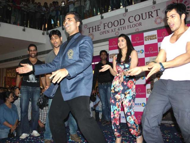 Director Karan Johar match steps with newcomers Varun Dhawan, Alia Bhatt and Siddharth Malhotra during movie's promotion. (UNI)