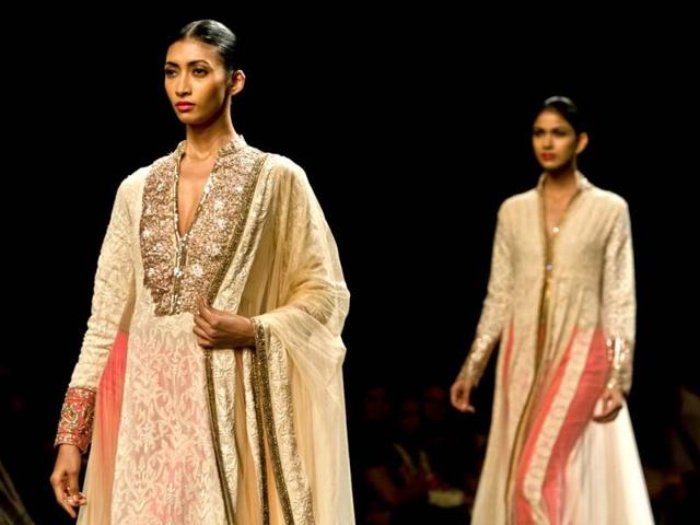 Models display creations by Manish Malhotra during the Wills Lifestyle India Fashion Week in New Delhi, India. (AP Photo/Tsering Topgyal)