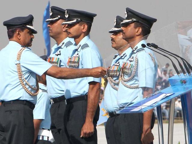 Air Chief Marshal NAK Browne honouring IAF personnel during the Air Force Day celebrations in Hindon. PTI Photo