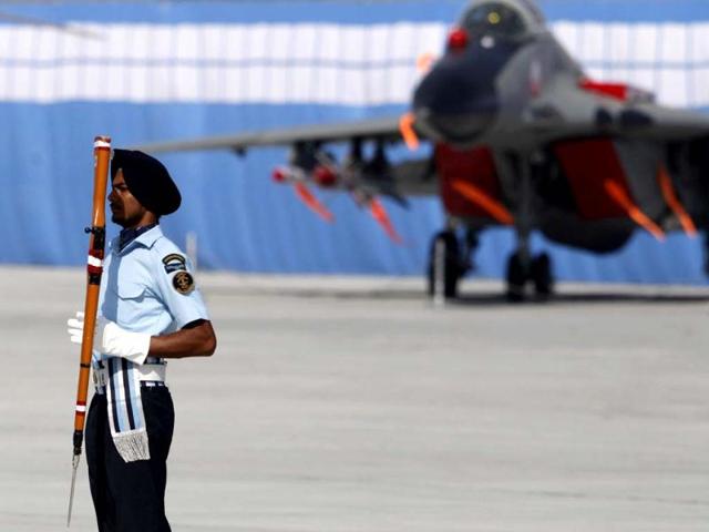 IAF drill team member displays rifle handling skills during Air Force Day celebrations in Hindon. AP Photo